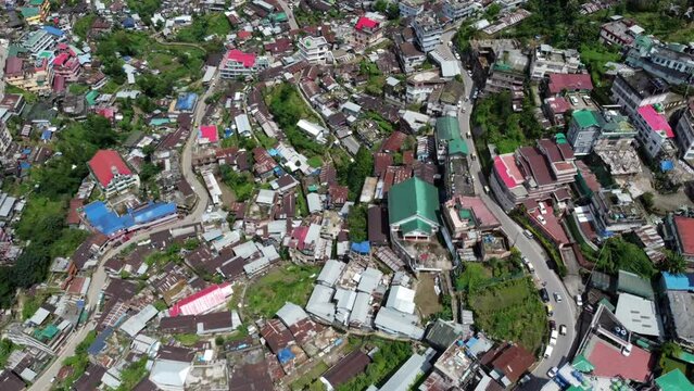 An incredible aerial flight and view of the houses and roads of the hill city of Kohima in Nagaland northeast India.