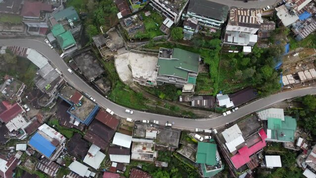 A spinning panning aerial view of the houses and roads of the hills city of Kohima in Nagaland northeast India.