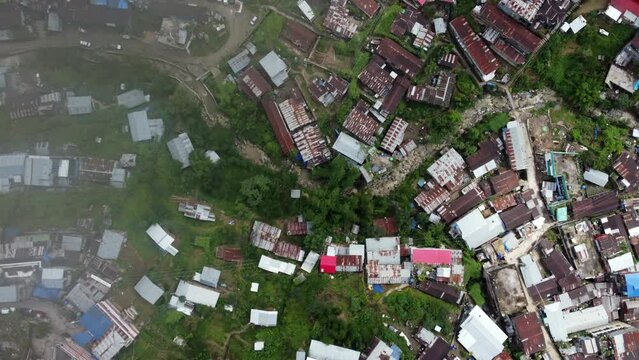 A straight down view aerial flight over the houses in the hill city of Kohima in Nagaland northeast India.