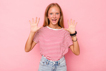 Caucasian teen girl isolated on pink background receiving a pleasant surprise, excited and raising hands.