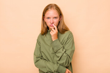 Caucasian teen girl isolated on beige background contemplating, planning a strategy, thinking about...