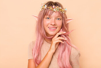 Little caucasian elf isolated on beige background