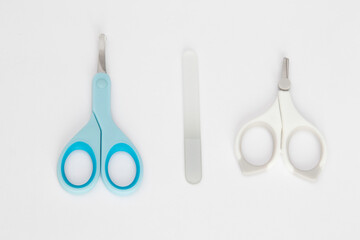 Baby nail care devices on a white background: scissors, nail file