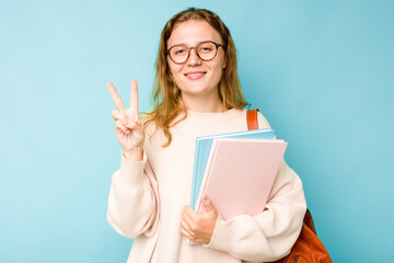 Young student caucasian woman isolated on blue background showing number two with fingers.