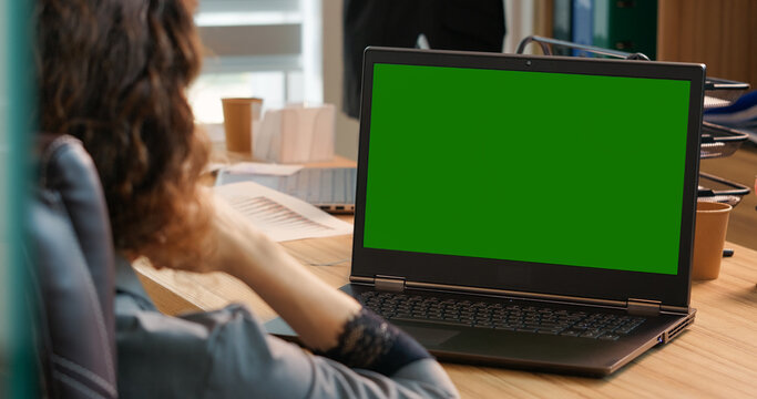 Entrepreneur checking reading and aswering email on green screen laptop in office. Employee having online stugying on a green screen chroma key laptop. - Powered by Adobe