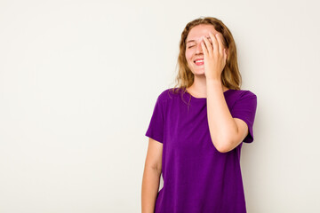 Young caucasian woman isolated on white background laughing happy, carefree, natural emotion.