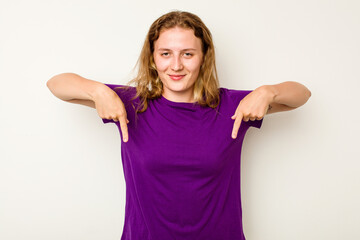 Young caucasian woman isolated on white background points down with fingers, positive feeling.