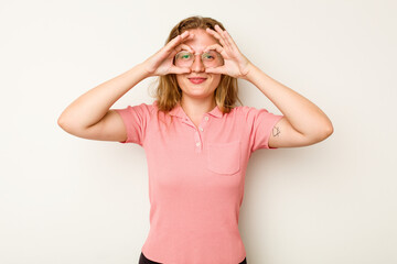 Young caucasian woman isolated on white background showing okay sign over eyes
