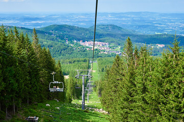 Beautiful mountains, covered with forest and open cable car line. Karpacz resort in Poland with...