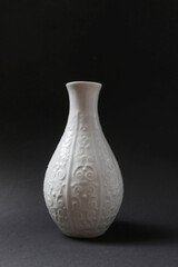 White porcelain vase on a black background.