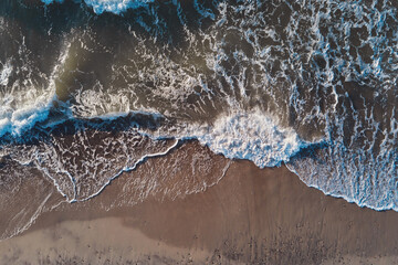 Sand beach with sea waves, top view. Summer vacation and travel concept. Beautiful coastline with baltic sea and sand beach, aerial view