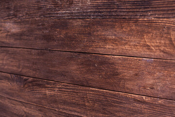 Vintage brown wood background texture with knots and nail holes. Old painted wood wall. Brown abstract background. Vintage wooden dark horizontal boards. Front view with copy space. Background for des
