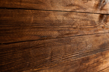 Vintage brown wood background texture with knots and nail holes. Old painted wood wall. Brown abstract background. Vintage wooden dark horizontal boards. Front view with copy space. Background for des