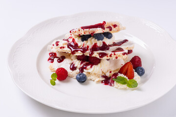 cream dessert with berries