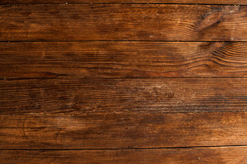 Fototapeta premium Vintage brown wood background texture with knots and nail holes. Old painted wood wall. Brown abstract background. Vintage wooden dark horizontal boards. Front view with copy space. Background for des