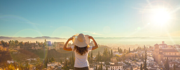 Panorama Alhambra in Granada and woman holiday maker - obrazy, fototapety, plakaty