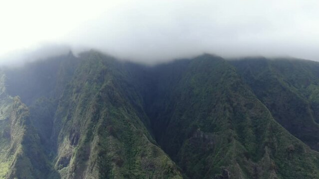 White mist covering the mountain peaks of West Maui, one of the wettest places on the Hawaiian islands.