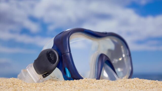 A snorkel mask on the beach
