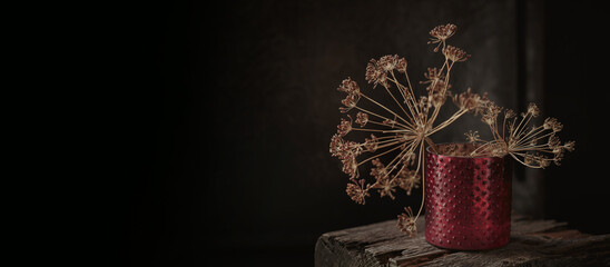 Art autumn dried flowers still life in a rustic style on a dark wooden background. Autumnal...