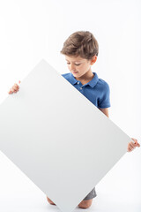 Child holding and looking at a white poster with space for text.