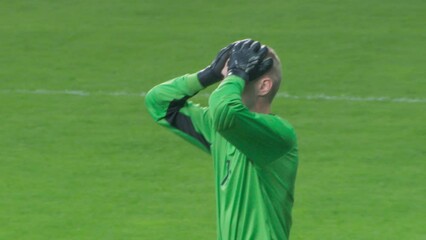 Soccer Football Championship Match: Blue Team Players Attack, Kick the Ball into the Gates, Goalkeeper Misses and the Goal is Scored, Focus on Goalie. Live Sport Channel Broadcast Television Playback