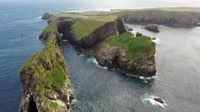 The cliffs and sea stacks An Tor Mor and the Wishing Stone at Port Challa on Tory Island, County Donegal, Ireland