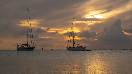 Fototapeta premium Sailing yachts drifting during sunset in Caribbean Sea