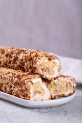 Turkish delight with almonds on a gray background. Turkish delight with almond cream filling. Close-up. local name bademli fitil lokum