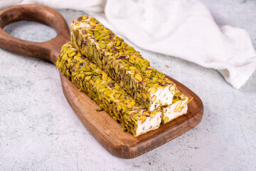Turkish delight with pistachio on a gray background. Turkish delight with milk. Close-up. local name fistikli fitil lokum