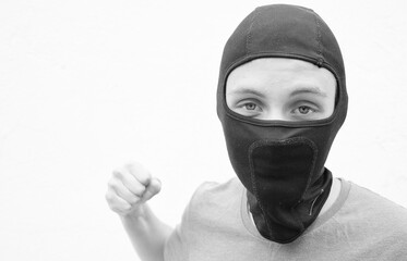 Portrait of a young man in a black balaclava