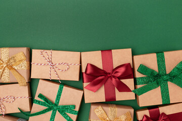 Wrapped gifts with ribbons on a green background. Boxing day concept with place for text.