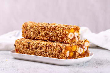 Turkish delight with hazelnut on gray background. Turkish delight covered with hazelnuts. Close-up. local name findikli fitil lokum