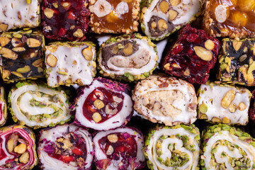Assortment of Turkish delight with pistachio on a gray background. Mixed Turkish Delight. Close-up. local name fistikli fitil lokum