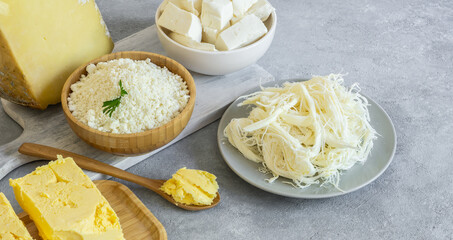 Delicatessen concept, different kinds of cheese and butter, cheddar, curd