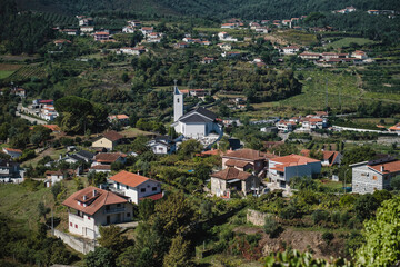 View of residential houses and a church in the hills of the Douro Valley, Porto, Portugal.