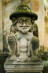 Fototapeta na wymiar Traditional guard statue in the street carved from stone in Bali, Indonesia.