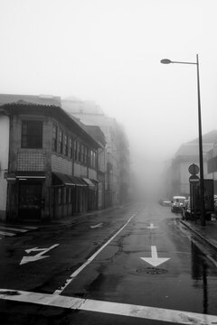 View of the buildings on foggy street, Porto, Portugal. Black and white photo.