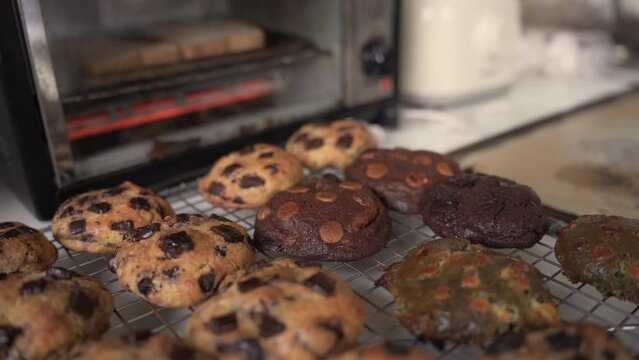 Tempting Assorted Cookies On A Cooling Rack Outside The Oven. dolly shot