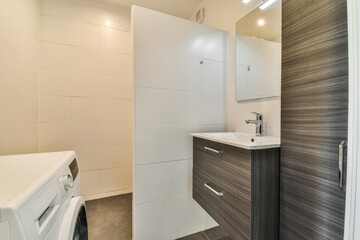 partition between shower tap and wall hung toilet in modern restroom at home