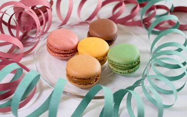 Close-up of macarons cakes of different pastel colors in white background. Culinary and cooking concept. Tasty colourful macaroons