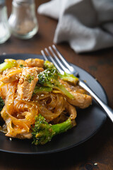 Stir fry, bean noodles with fried chicken fillet and broccoli