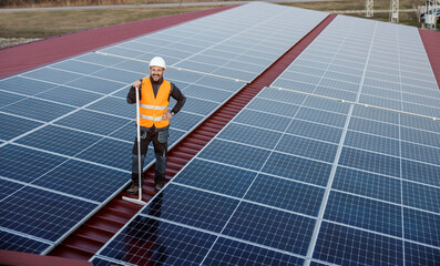 A happy worker finished cleaning solar panels.