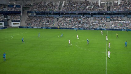Soccer Football Championship Stadium with Crowd of Fans: Blue Team Attack and Score Goal, Players Celebrate Victory, Winners of Tournament. Sport Channel Broadcast Television Playback. High Angle Wide