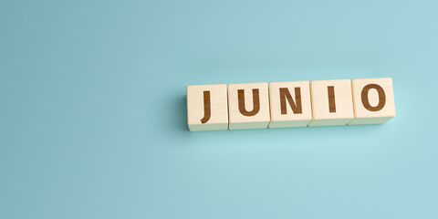 The Spanish word Junio (June) built from letters on wooden cubes. High angle view with copy space
