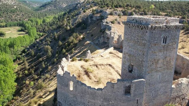 Aerial view, round flght around a medieval castle in Ucero, Soria, Spain.