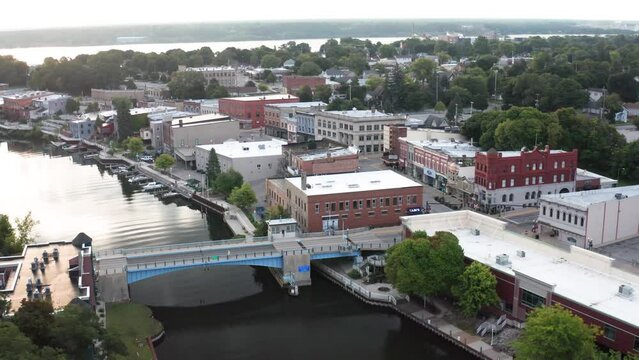 Manistee, Michigan downtown skyline with drone video moving over bridge moving in.