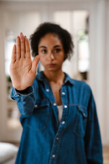 Young black woman gesturing stop sign and protesting against abortion