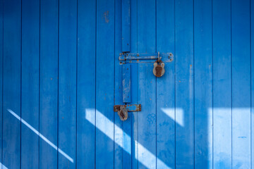 Blue wooden door with two padlocks