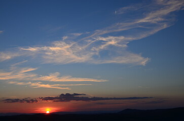 Sunset falling over the beautiful countryside and town of Montepulciano in Tuscany on a bright summer day