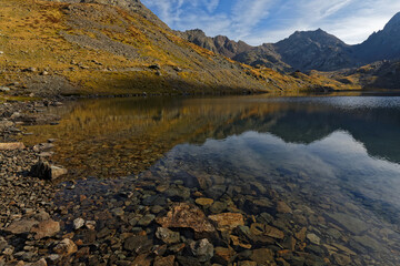 Lac du Grand Domenon mounatin lake at the first rays of morning sun